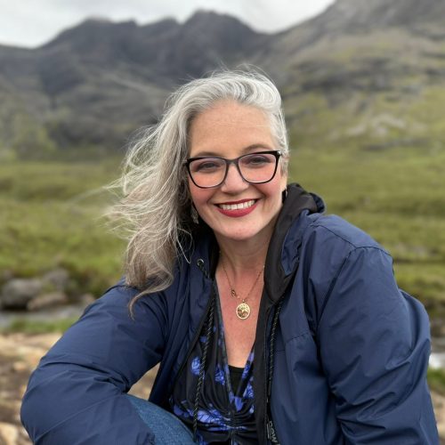 Image of Roberta Heath sitting in a Fairy glen at the Isle of Skye in northern Scotland.